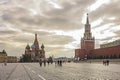 Red Square during autumn with people and the iconic St. Basil`s Cathedral and Spasskaya Tower in Moscow, Russia. Royalty Free Stock Photo