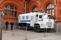 On Red Square, behind the fence, there is a police car for transporting detainees and police officers
