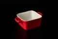 Red ceramic baking dish. Isolated on black background Royalty Free Stock Photo