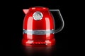 Red stainless electric tea kettle, retro design on black background, 3D rendering Royalty Free Stock Photo