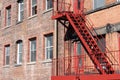 Red Stairs on a Fire Escape on the Side of an Old Building in New York City Royalty Free Stock Photo