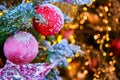 Red star and balls hanging as decorations on a snow-covered Christmas tree, close-up Royalty Free Stock Photo