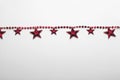 Red star garland on white backgroun. Flat lay. Top view