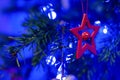 Red Star Hanging On Christmas Tree. Christmas Tree Decoration. Festive Ornament. Greeting Card Concept Royalty Free Stock Photo