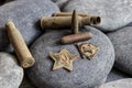 A red star from a military cap and a Komsomol badge, along with casings and bullets from a 7.62mm Mosin rifle Royalty Free Stock Photo