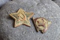 A red star from a military cap and a Komsomol badge Royalty Free Stock Photo