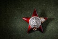 Red Star order on green background, Russia. Old Russian military medal Royalty Free Stock Photo