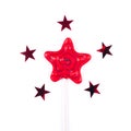 Red star shaped lollipop on white background. Royalty Free Stock Photo