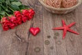 Red starfish, heart and red roses on a table