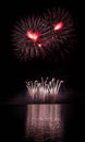 Red stars and gold fountain from rich fireworks over Brno`s Dam with lake reflection Royalty Free Stock Photo