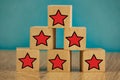 Red stars on wooden cubes on a blue background. Stars mean assessing quality. five-point rating system