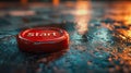 A red 'Start' button on a wet surface. Royalty Free Stock Photo