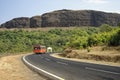 Red state transport bus on mountain road