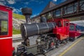 Red steam historic locomotive waiting in Schafbergspitze station in Austria