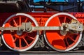 Red steam locomotive wheels, metal wheels of an old steam locomotive