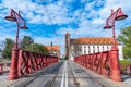 Red steel construction on sand bridge to island at city center Royalty Free Stock Photo