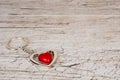 Red steel heart keyring on wooden table