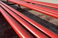 Red steel pipes for fire fighting system and extinguishing water lines in industrial building. Paint shop. Steel pipe painted red Royalty Free Stock Photo