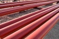 Red steel pipes for fire fighting system and extinguishing water lines in industrial building. Paint shop. Steel pipe painted red Royalty Free Stock Photo