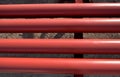 Red steel pipes for fire fighting system and extinguishing water lines in industrial building. Paint shop. Steel pipe painted red Royalty Free Stock Photo