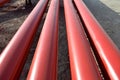 Red steel pipes for fire fighting system and extinguishing water lines in industrial building. Paint shop. Steel pipe painted red Royalty Free Stock Photo