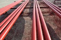 Red steel pipes for fire fighting system and extinguishing water lines in industrial building. Paint shop. Steel pipe painted red Royalty Free Stock Photo