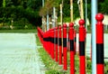 Red steel post and bollards in diminishing perspective. soft green background