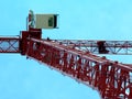 Red steel tower construction crane in abstract perspective view. clear blue sky
