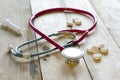 Red stethoscope and pills Royalty Free Stock Photo
