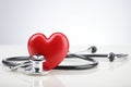 Red stethoscope in shape of heart on a white background. Generative AI Royalty Free Stock Photo
