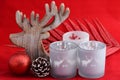 Red still life background with grey, white wooden reindeer Christmas decoration lights Royalty Free Stock Photo