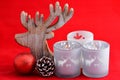 Red still life background with grey, white wooden reindeer Christmas decoration Royalty Free Stock Photo