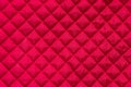Red stitched quilted bag cloth background close up Royalty Free Stock Photo