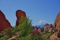 Red stone desert scene with towering rock and mountains