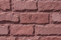 Red stone wall background. The texture of the decorative stone. Close-up