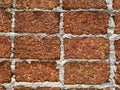 Red stone wall stacked up grout with grey cement Rock porous rough surface material texture background Royalty Free Stock Photo
