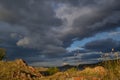 Red stones bay of lake baikal with yellow dry grass in autumn. Blue water with islands, clouds Sunset light. Royalty Free Stock Photo