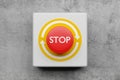 Red stop or panic push button on concrete wall background, emergency, security or safety concept