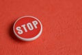 Red STOP pin on red background symbolizing warning and road safety alerts Royalty Free Stock Photo