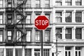 Red stop sign against background of old black and white buildings in SoHo Manhattan, New York City Royalty Free Stock Photo