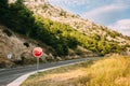 Red stop sign near the mountain road Royalty Free Stock Photo