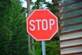 Red stop sign with trees in background Royalty Free Stock Photo