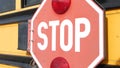 Red stop sign, yellow school bus in USA. Schoolbus or shuttle, safety on road. Royalty Free Stock Photo