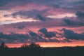 red storm clouds over meadow with green grass - vintage effect Royalty Free Stock Photo