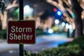 Red storm shelter sign illuminated by night light with blurred background Royalty Free Stock Photo