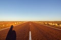 red straight road with red dessert on the Stuart Highway north of copper pedy, South Australia Royalty Free Stock Photo