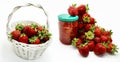 Red strawberries in the basket and on the table isolated on white Royalty Free Stock Photo