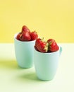 Red strawberries in blue circles on a light green and yellow lime background Royalty Free Stock Photo