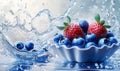Red strawberries and blueberries cascade from a light blue paper cup positioned on a white surface Royalty Free Stock Photo