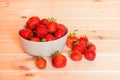 Red strawberries in bowl on wooden table. Selective focus Royalty Free Stock Photo